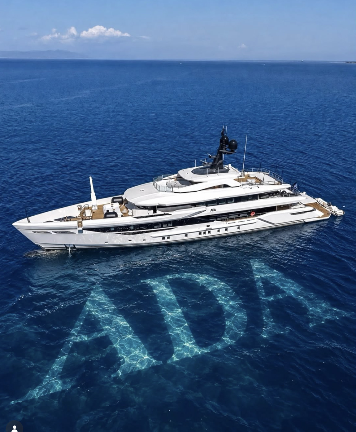 A luxury yacht cruising across clear blue water