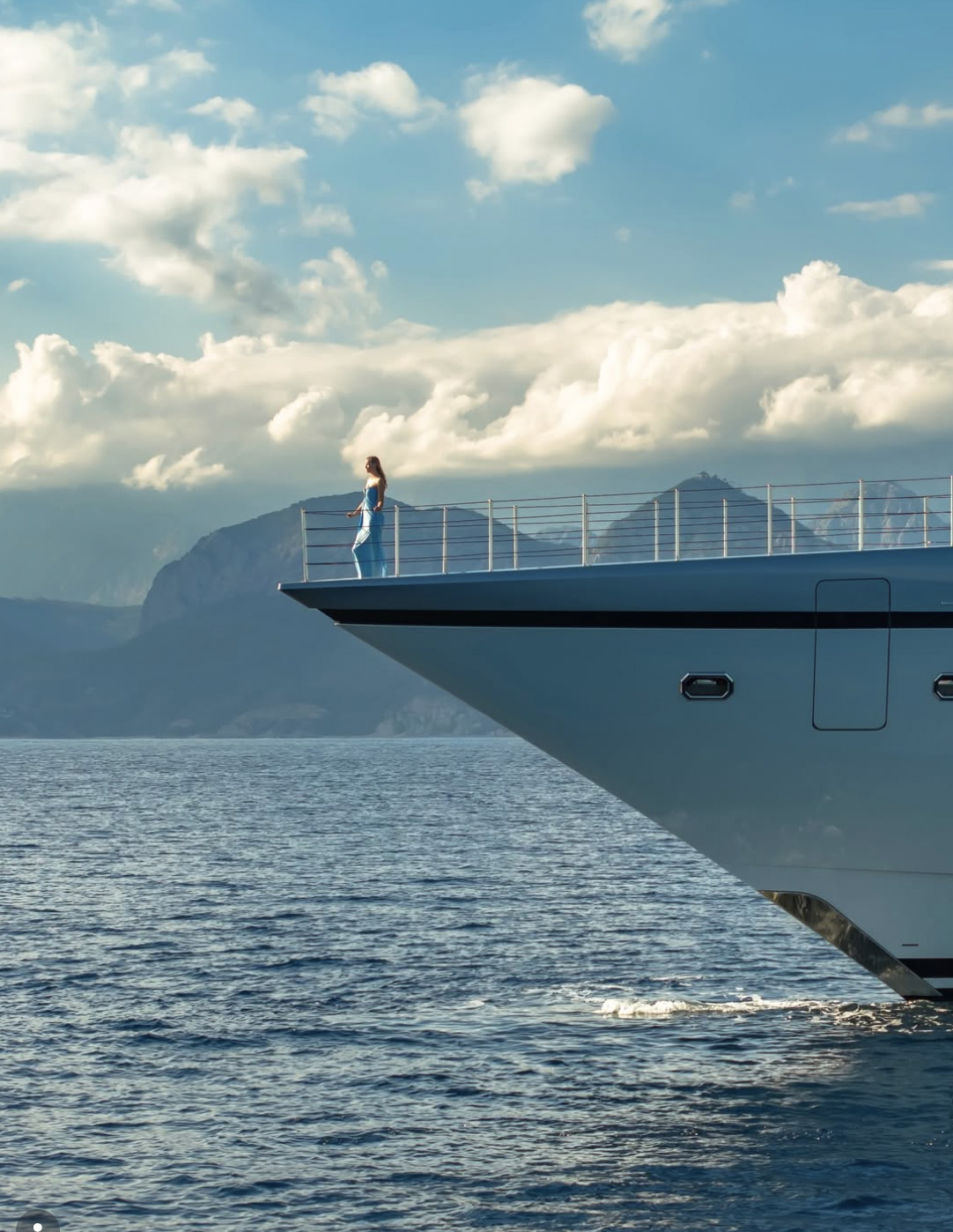 Yacht bow and guest on deck at sea